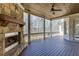 Covered deck area with a stone fireplace that overlooks the backyard at 4296 Alba Ln, Buford, GA 30519