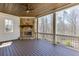 Covered porch with a stone fireplace and ceiling fan, perfect for relaxing outdoors at 4296 Alba Ln, Buford, GA 30519