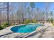 Beautiful pool with lounge chairs on the patio with an open yard at 4296 Alba Ln, Buford, GA 30519