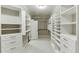 A large walk-in closet with white shelving and drawers throughout the space at 4296 Alba Ln, Buford, GA 30519