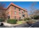 Three-story brick apartment building featuring a red tile roof and well-maintained landscaping at 708 Argonne Ne Ave # 5, Atlanta, GA 30308