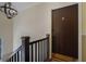 A brown front door with a peephole and decorative door knocker sits at the top of a wooden staircase at 708 Argonne Ne Ave # 5, Atlanta, GA 30308