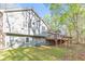 View of backyard showing house, deck, forest and well maintained lawn at 1013 Harbor Ct, Woodstock, GA 30189