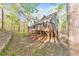View of backyard showing house, deck, forest and walking path with fence at 1013 Harbor Ct, Woodstock, GA 30189