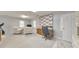 A versatile finished basement features gym equipment, an office space, and cozy seating areas at 1013 Harbor Ct, Woodstock, GA 30189
