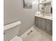 Powder room with marble floors and a gray vanity at 1013 Harbor Ct, Woodstock, GA 30189