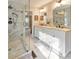 Spacious bathroom featuring double vanity, marble floors, updated fixtures, and glass shower at 1013 Harbor Ct, Woodstock, GA 30189