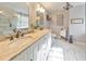 Bright bathroom featuring double vanity with cream counters, marble floors, and a glass shower at 1013 Harbor Ct, Woodstock, GA 30189