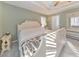 Comfortable bedroom with tray ceiling, neutral color scheme, and abundant natural light at 1013 Harbor Ct, Woodstock, GA 30189