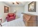 Bedroom with red leather chair, wood desk, and neutral carpet at 1013 Harbor Ct, Woodstock, GA 30189