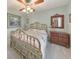 Cozy bedroom with brass bed frame, side table, and dresser at 1013 Harbor Ct, Woodstock, GA 30189