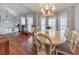 Elegant dining room with hardwood floors, large windows, and chandelier lighting at 1013 Harbor Ct, Woodstock, GA 30189