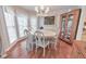 Elegant dining room with a chandelier, large windows, and a classic cabinet at 1013 Harbor Ct, Woodstock, GA 30189