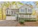 Charming exterior of home featuring a two-car garage and a spacious front porch with white railings at 1013 Harbor Ct, Woodstock, GA 30189