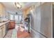 Bright kitchen with stainless steel refrigerator, granite countertops, and hardwood floors at 1013 Harbor Ct, Woodstock, GA 30189