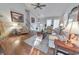 Comfortable living room with a stone fireplace, hardwood floors, neutral furnishings, and large windows at 1013 Harbor Ct, Woodstock, GA 30189