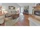 Comfortable living room with a stone fireplace, hardwood floors, and a large window, perfect for relaxation at 1013 Harbor Ct, Woodstock, GA 30189