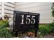 Close up of black sign displaying the house number '155 Breakspear' surrounded by greenery at 155 Breakspear Ln, Fayetteville, GA 30214