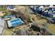 Expansive aerial view features tennis and basketball courts, a pond, walking paths, and green spaces surrounded by homes at 155 Breakspear Ln, Fayetteville, GA 30214