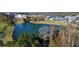 Scenic aerial view of a lake surrounded by buildings, homes, and lush greenery, capturing the neighborhood's beauty at 155 Breakspear Ln, Fayetteville, GA 30214