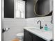 Modern half-bath featuring a black vanity with a white marble countertop, black fixtures, and shiplap paneling at 155 Breakspear Ln, Fayetteville, GA 30214