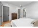 Bright bedroom with a queen-size bed, hardwood floors, a dresser, and access to the en-suite bathroom at 155 Breakspear Ln, Fayetteville, GA 30214
