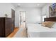 Bright bedroom featuring a queen bed, hardwood floors, a chest of drawers, and multiple windows at 155 Breakspear Ln, Fayetteville, GA 30214
