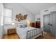 Cozy bedroom with hardwood floors, woven wall decor, and plenty of natural light at 155 Breakspear Ln, Fayetteville, GA 30214