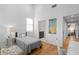 Well-lit bedroom boasts hardwood floors, high ceilings and ensuite bathroom access at 155 Breakspear Ln, Fayetteville, GA 30214