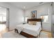 Bright bedroom featuring two windows, a queen bed, and an open doorway to the living area at 155 Breakspear Ln, Fayetteville, GA 30214