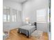 Bright bedroom featuring hardwood floors, a large window, and a cozy rug at 155 Breakspear Ln, Fayetteville, GA 30214