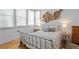 Serene bedroom showcases lots of natural light, hardwood floors, and stylish decor at 155 Breakspear Ln, Fayetteville, GA 30214
