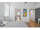 Bright bedroom with hardwood floors features a large window with modern decor at 155 Breakspear Ln, Fayetteville, GA 30214