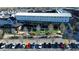 Aerial shot of Fairway Social with a paved parking lot, trees, and the adjacent lawn with people sitting at 155 Breakspear Ln, Fayetteville, GA 30214