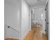 Light-filled hallway with hardwood floors leads to a bright office with white walls at 155 Breakspear Ln, Fayetteville, GA 30214