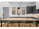 A kitchen island complements the gray cabinets and marble countertops in this home at 155 Breakspear Ln, Fayetteville, GA 30214