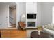 Stylish living room with fireplace, hardwood floors, and an open staircase at 155 Breakspear Ln, Fayetteville, GA 30214