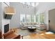 Bright living room boasts large windows, hardwood floors, and a comfortable sectional sofa at 155 Breakspear Ln, Fayetteville, GA 30214