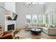 Bright and airy living room with large windows, fireplace, and modern furnishings at 155 Breakspear Ln, Fayetteville, GA 30214