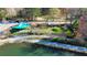Aerial view of a charming mini golf course with a blue awning, adjacent to a serene lake and walking path at 155 Breakspear Ln, Fayetteville, GA 30214