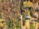 An aerial view shows the location of both homes and outbuildings on this large wooded lot at 2466 Thrasher Rd, Buford, GA 30519