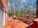 Spacious wooden back deck offers ample seating, views of the surrounding trees, and natural light at 2466 Thrasher Rd, Buford, GA 30519