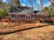 Back of the home featuring a large wooden deck, ideal for outdoor entertaining at 2466 Thrasher Rd, Buford, GA 30519