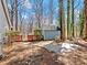 Home's backyard with stone fire pit area and tranquil wooded setting at 2466 Thrasher Rd, Buford, GA 30519