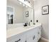 Elegant bathroom featuring a modern vanity with white cabinets and matte black hardware at 2466 Thrasher Rd, Buford, GA 30519