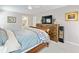 Bright bedroom featuring a sleigh bed, a dresser, and natural light from the windows at 2466 Thrasher Rd, Buford, GA 30519