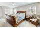 Light and airy bedroom featuring a decorative bed frame, ceiling fan, and natural light at 2466 Thrasher Rd, Buford, GA 30519