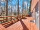 A spacious wooden deck with room for outdoor seating, perfect for enjoying the surrounding wooded scenery at 2466 Thrasher Rd, Buford, GA 30519