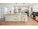 Open-concept kitchen features a large island with pendant lighting and modern appliances at 2466 Thrasher Rd, Buford, GA 30519