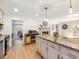 Modern kitchen featuring granite countertops, pendant lighting, and an open view to the living room at 2466 Thrasher Rd, Buford, GA 30519